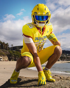 Phenom Elite SpongeBob football cleat lifestyle photo — athlete in action wearing cleats