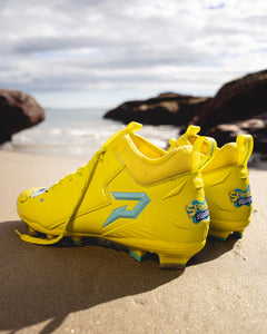 Phenom Elite SpongeBob football cleat lifestyle photo — athlete posing with cleats
