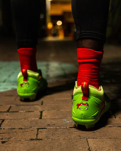 Phenom Elite Raphael football cleat lifestyle photo — close-up of cleats on field