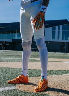 Phenom Elite Flintstones football gloves lifestyle photo — orange Bedrock Blitz gloves in action