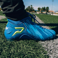 Phenom Elite Kool-Aid Bluedini football cleat lifestyle photo — cleats with packet