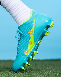 Phenom Elite Scooby-Doo football cleat lifestyle photo — product detail on field
