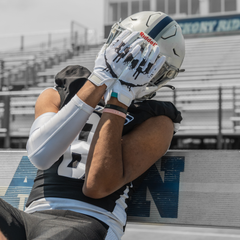 Phenom Elite Sinister VPS1 Vapor-Stick football gloves — lifestyle photo on field